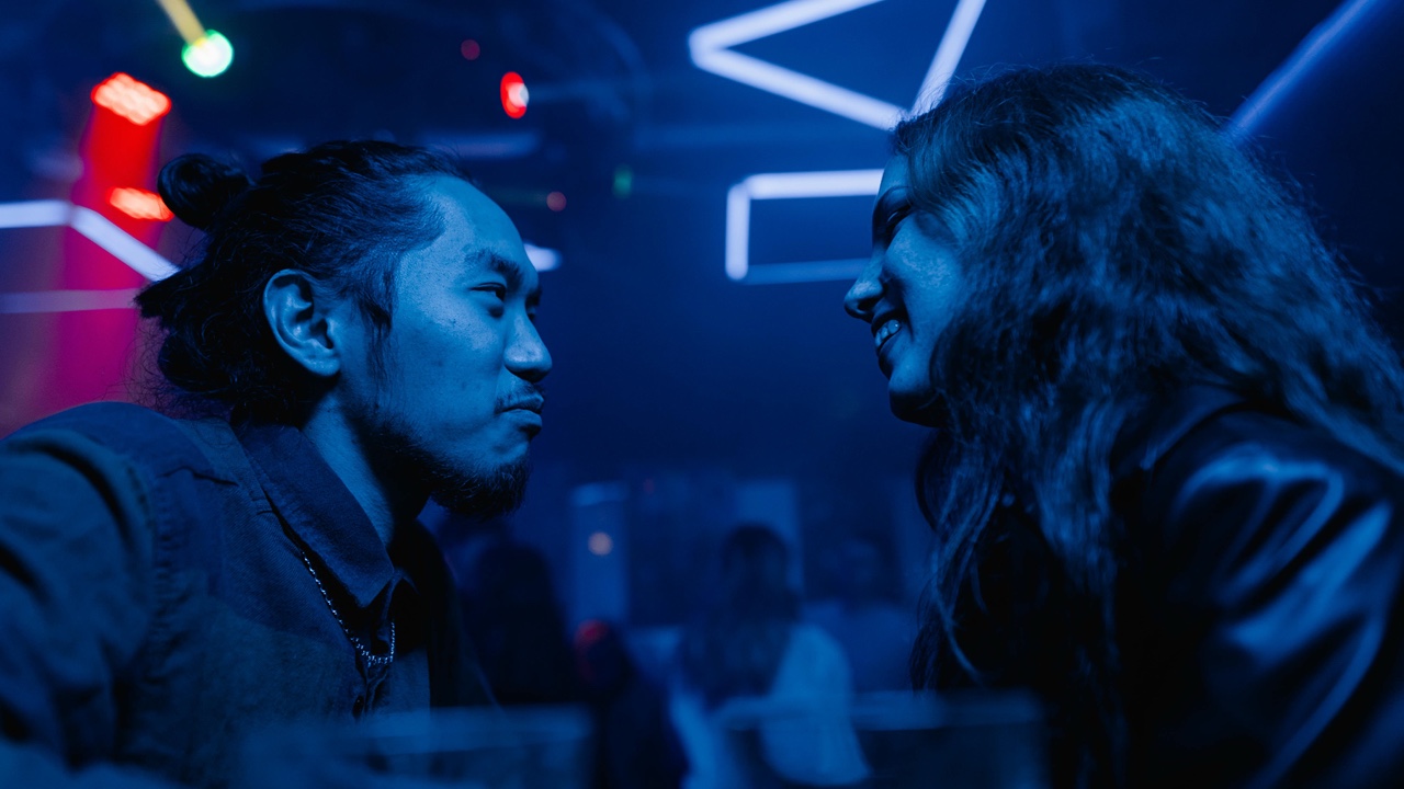 Man and woman flirting in night club